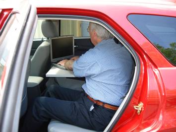 Employee Working from Rear Seat in Mobile Office Interior